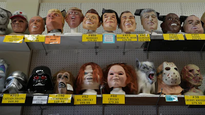 A variety of face masks line the shelves at the House of Humor costume shop in Redwood City, Calif., Thursday, Sept. 18, 2025.