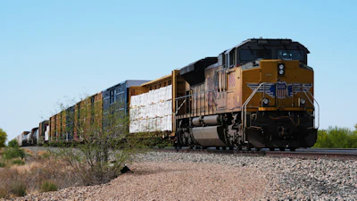 A Union Pacific freight train idles on the track as it waits to continue moving, Thursday, April 17, 2025, in Red Rock, Ariz.