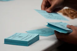 A volunteer sorts votes on a new contract offer from Boeing, Nov. 4, 2024, at the IAM District 751 Union Hall in Seattle.