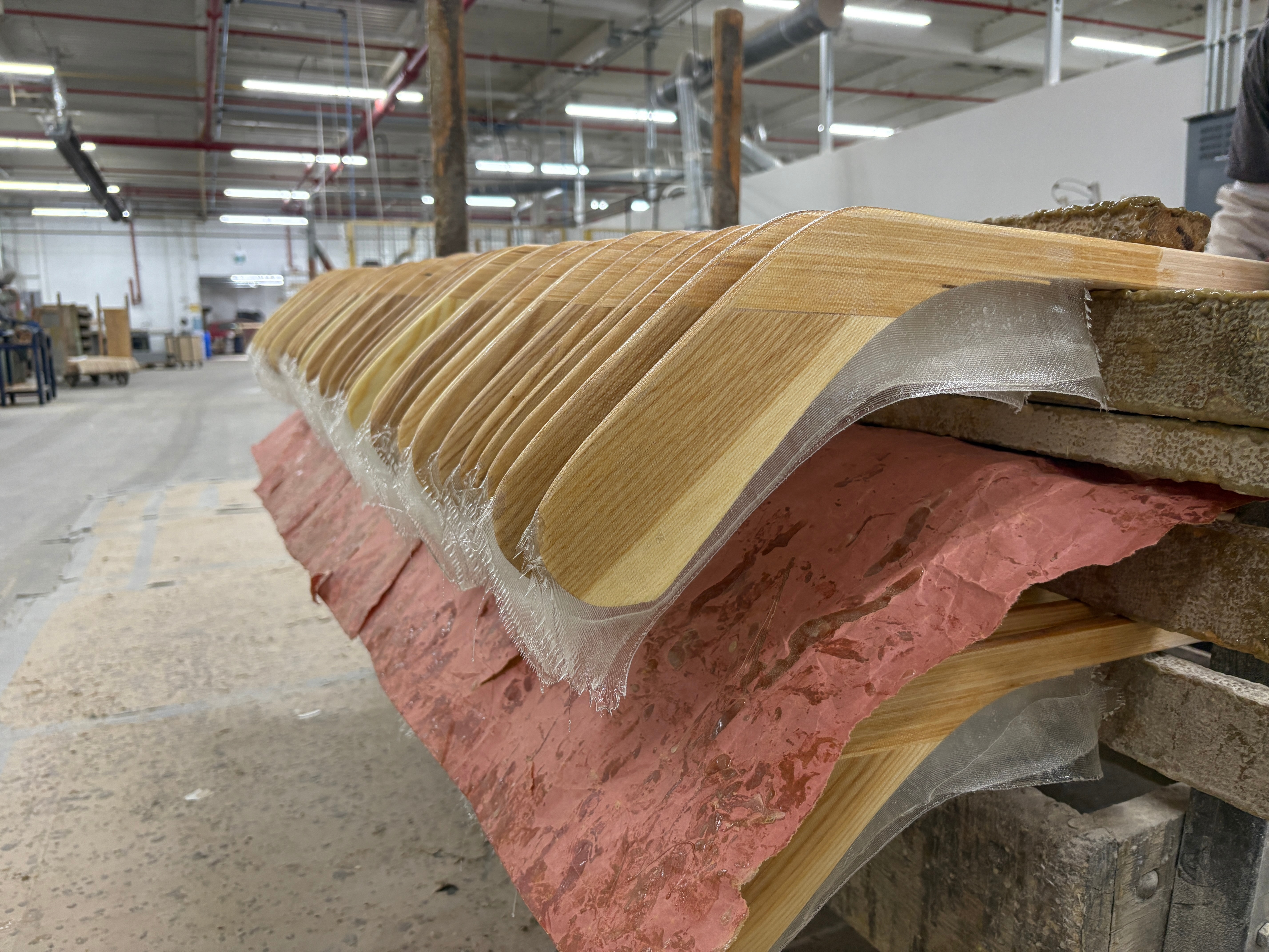 Wooden hockey sticks are stacked as they move along the assembly line at the Roustan Hockey factory, which is the last major manufacturer of hockey sticks in Canada on Aug. 27, 2025 in Brantford, Ontario.