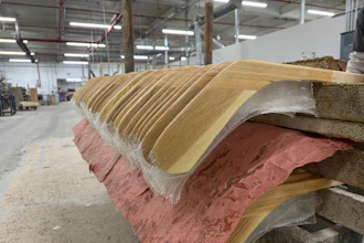Wooden hockey sticks are stacked as they move along the assembly line at the Roustan Hockey factory, which is the last major manufacturer of hockey sticks in Canada on Aug. 27, 2025 in Brantford, Ontario.