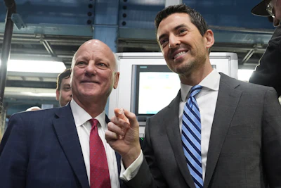U.S. Treasurer Brandon Beach, left, and Deputy Secretary of the Treasury Derek Theurer pose for a picture holding one of the last pennies pressed at the U.S. Mint in Philadelphia, Wednesday, Nov. 12, 2025.