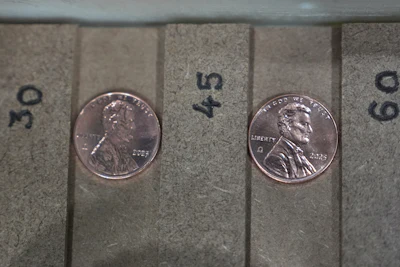 Two of the last five pennies pressed at the U.S. Mint are presented during a news conference in Philadelphia, Wednesday, Nov. 12, 2025.