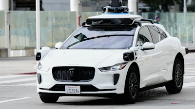 A passenger inside a Waymo vehicle looks out of the window while leaving the San Jose Mineta International Airport, Wednesday, Nov. 12, 2025, in San Jose, Calif.