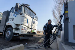 A driver charges his electric truck at a charging station on the outskirts of Beijing, on Nov. 14, 2025.