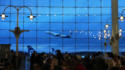 An Alaska Airlines airplane is seen from the central terminal as it takes off at Seattle-Tacoma International Airport Sunday, Nov. 23, 2025, in SeaTac, Wash.
