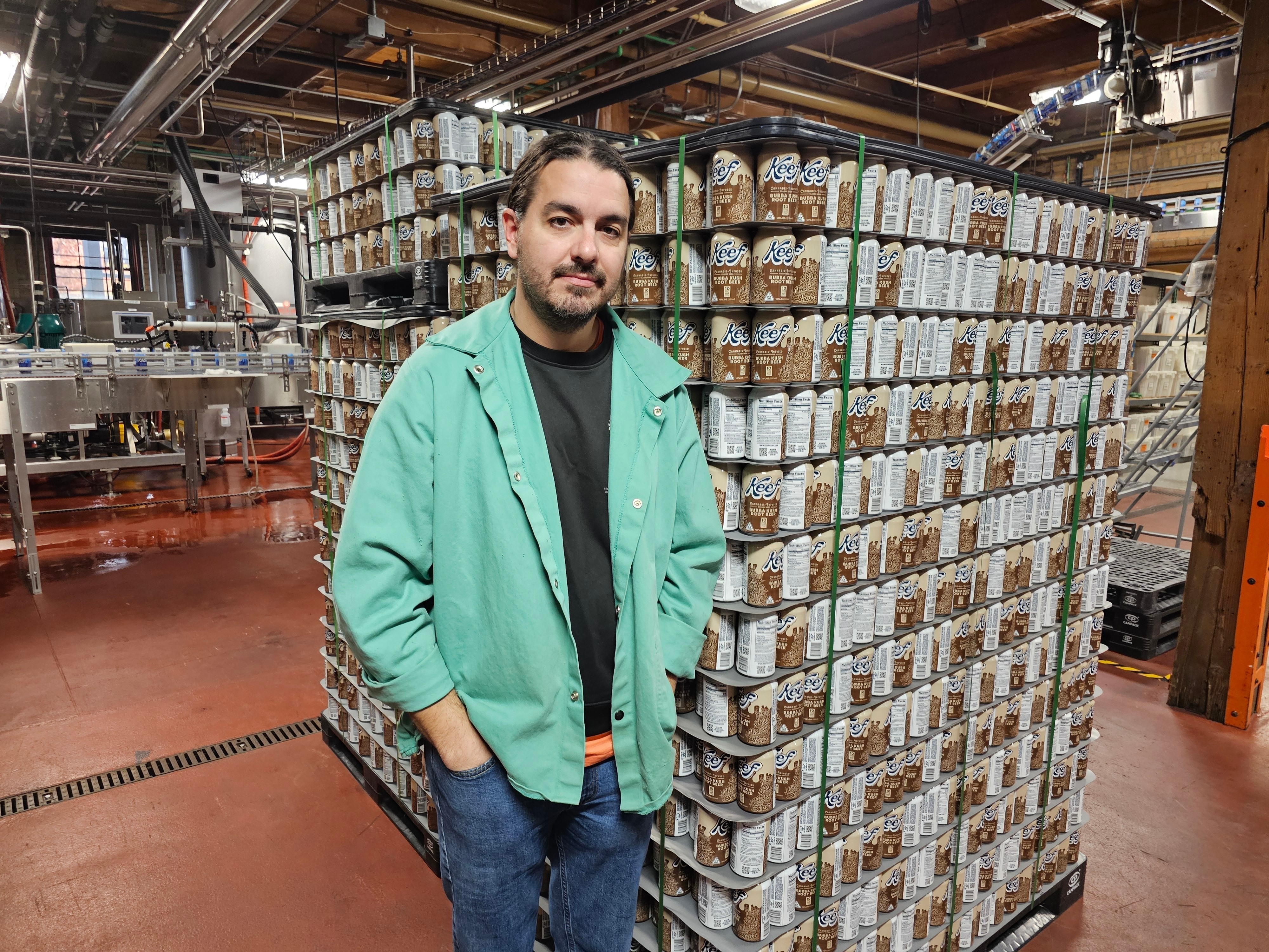 Ryan Bandy, chief business officer at Indeed Brewing in Minneapolis, stands near a pallet of six-packs of seltzer containing THC, the active ingredient in marijuana, in his brewery on Thursday, Nov. 20, 2025.