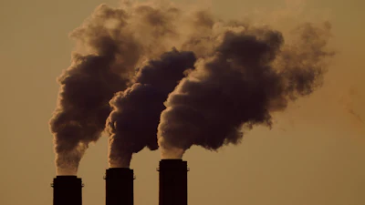 Emissions rise from the smokestacks at the Jeffrey Energy Center coal power plant as the suns sets, near Emmett, Kansas, Sept. 18, 2021.