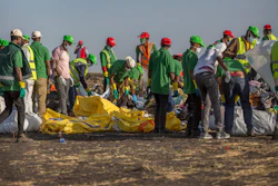 Workers collect debris on March 12, 2019 at the scene where an Ethiopian Airlines Boeing 737 Max 8 crashed shortly after takeoff, killing all 157 on board, near Bishoftu, or Debre Zeit, south of Addis Ababa, in Ethiopia.
