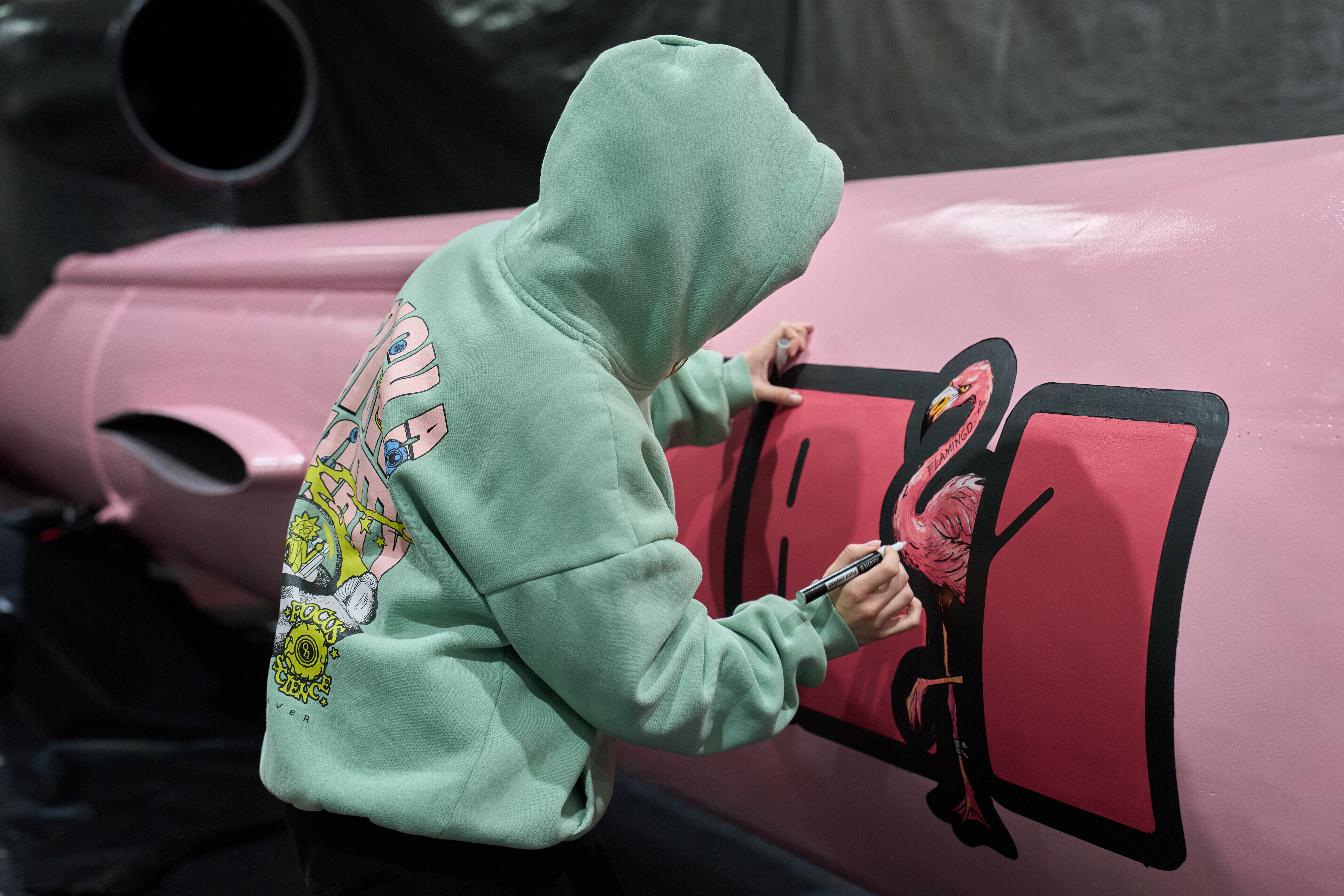 A painter writes 'Dana 1' referring to Czech nuclear physicist Dana Drabova on the side of a Flamingo cruise missile, which was paid by a crowdfunding campaign of a Czech organization, Weapons to Ukraine, at the Fire Point factory at an undisclosed location in Ukraine, Sunday, Nov. 16, 2025.