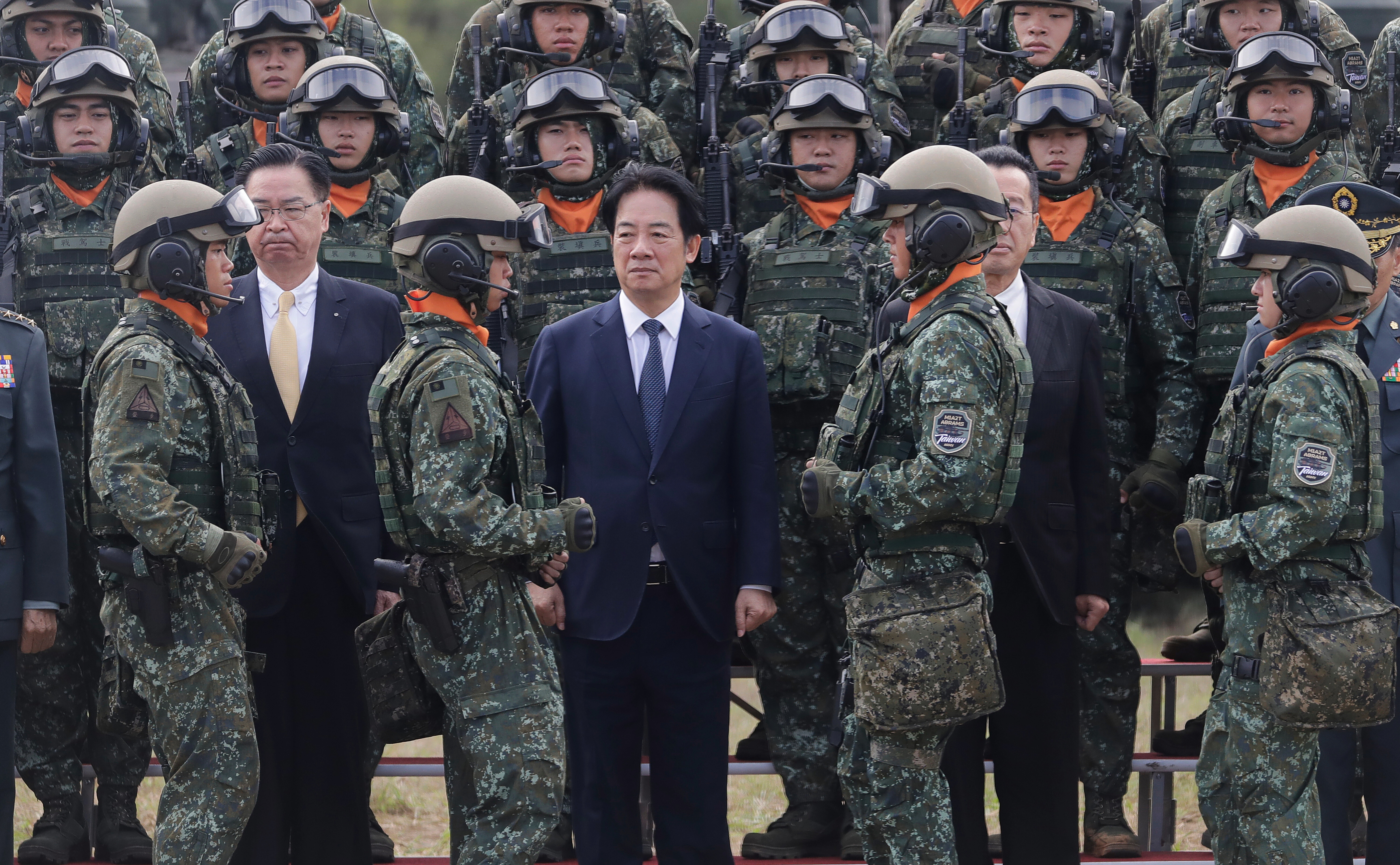 Taiwan's President Lai Ching-te, center, waits for a group photo with soldiers during the inauguration ceremony of M1A2T Abrams Main Battle Tanks in Hsinchu County, Taiwan, Friday, Oct. 31, 2025.