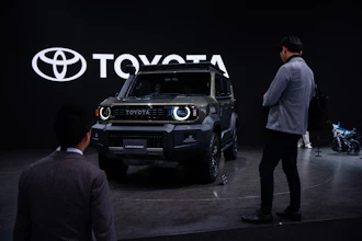 Members of the media and guests look at Toyota's Corolla concept during the press day of the Japan Mobility Show, in Tokyo, Thursday, Oct. 30, 2025.