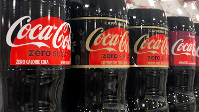 Bottles of Coca-Cola products sit on a shelf at a store in Dania Beach, Fla., Oct. 20, 2020.