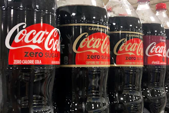 Bottles of Coca-Cola products sit on a shelf at a store in Dania Beach, Fla., Oct. 20, 2020.