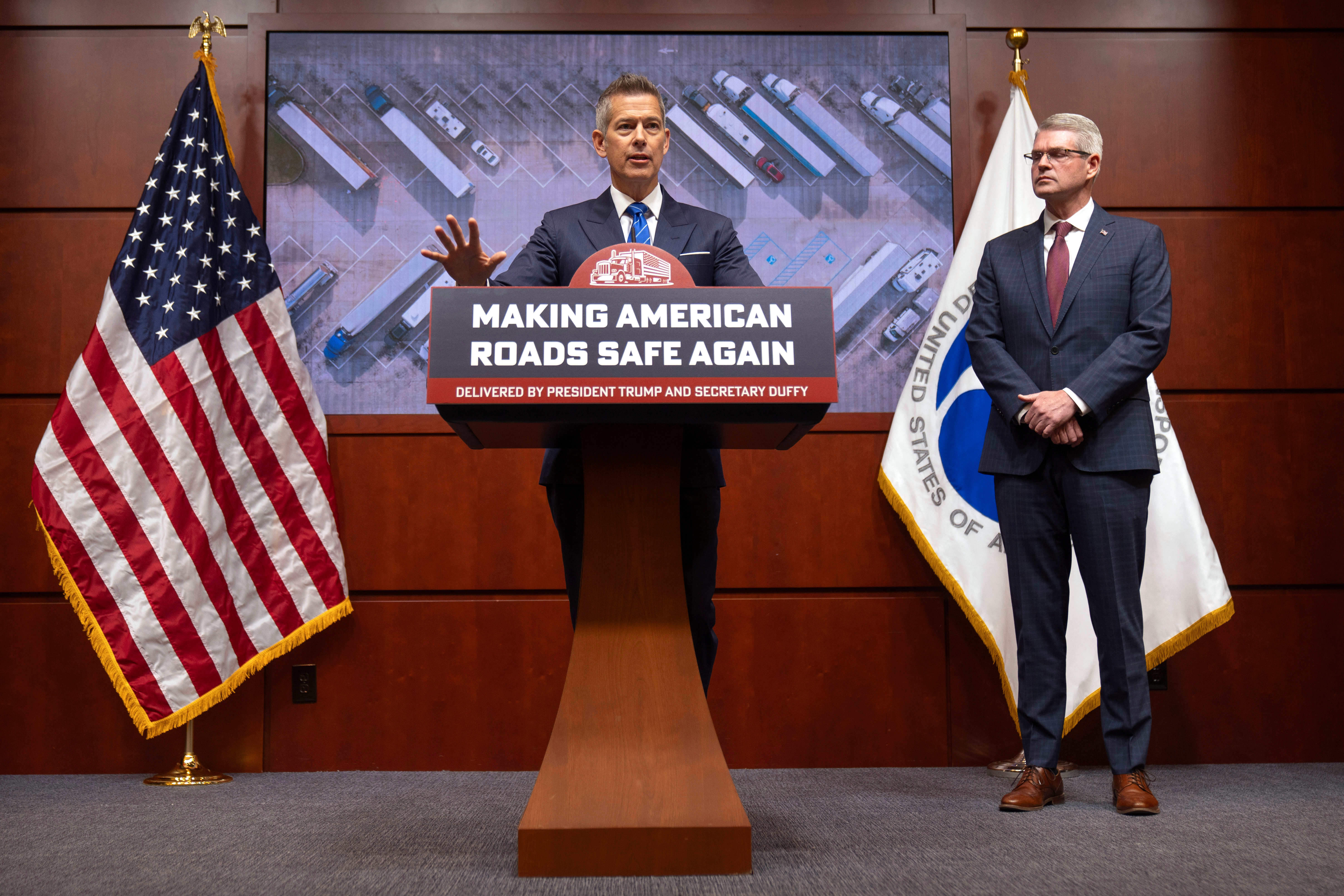 Transportation Secretary Sean Duffy speaks alongside Derek Barrs, administrator of the Federal Motor Carrier Safety Administration, during a news conference in Washington, Dec. 12, 2025.