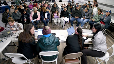 Tyson Foods employees at an informational meeting held by the Nebraska Department of Labor in Lexington, Neb., Dec. 3, 2025.