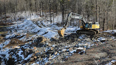 An excavator moves rocks at a graphite mine, Nov. 20, 2025, in Gouverneur, N.Y.
