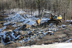 An excavator moves rocks at a graphite mine, Nov. 20, 2025, in Gouverneur, N.Y.