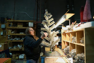Melissa Webb assembles an artificial Christmas tree at Lee Display's warehouse, in Fairfield, Calif., Tuesday, Dec. 9, 2025.