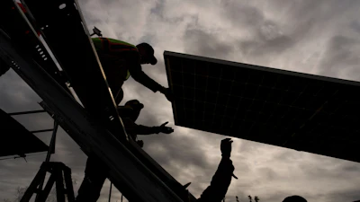 Workers install panels at a solar project May 21, 2025, in Galena, Alaska.