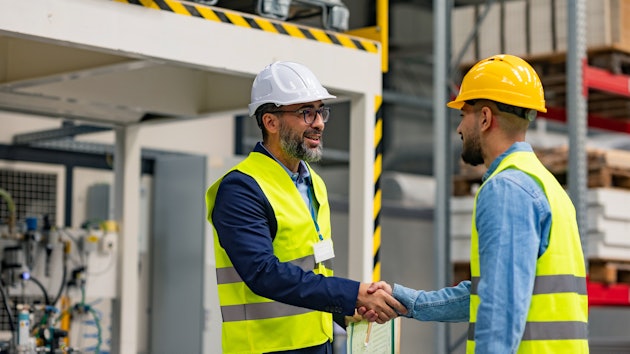 Engineer shaking hands with project manager.