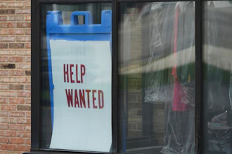 'Help Wanted' sign is displayed at a dry cleaner in Rolling Meadows, Ill., Thursday, May 15, 2025.