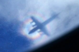 The shadow of a Royal New Zealand Air Force P3 Orion is seen on low level cloud while the aircraft searches for missing Malaysia Airlines Flight MH370 in the southern Indian Ocean, near the coast of Western Australia, March 31, 2014.