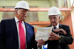 Federal Reserve Chairman Jerome Powell, right, and President Donald Trump look over a document of cost figures during a visit to the Federal Reserve, July 24, 2025, Washington.