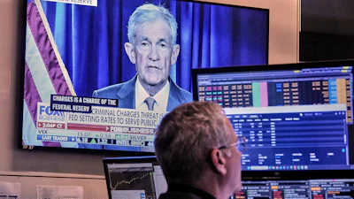 A video of Federal Reserve Chair Jerome Powell plays on a screen on the floor of the New York Stock Exchange, Jan. 12, 2026.