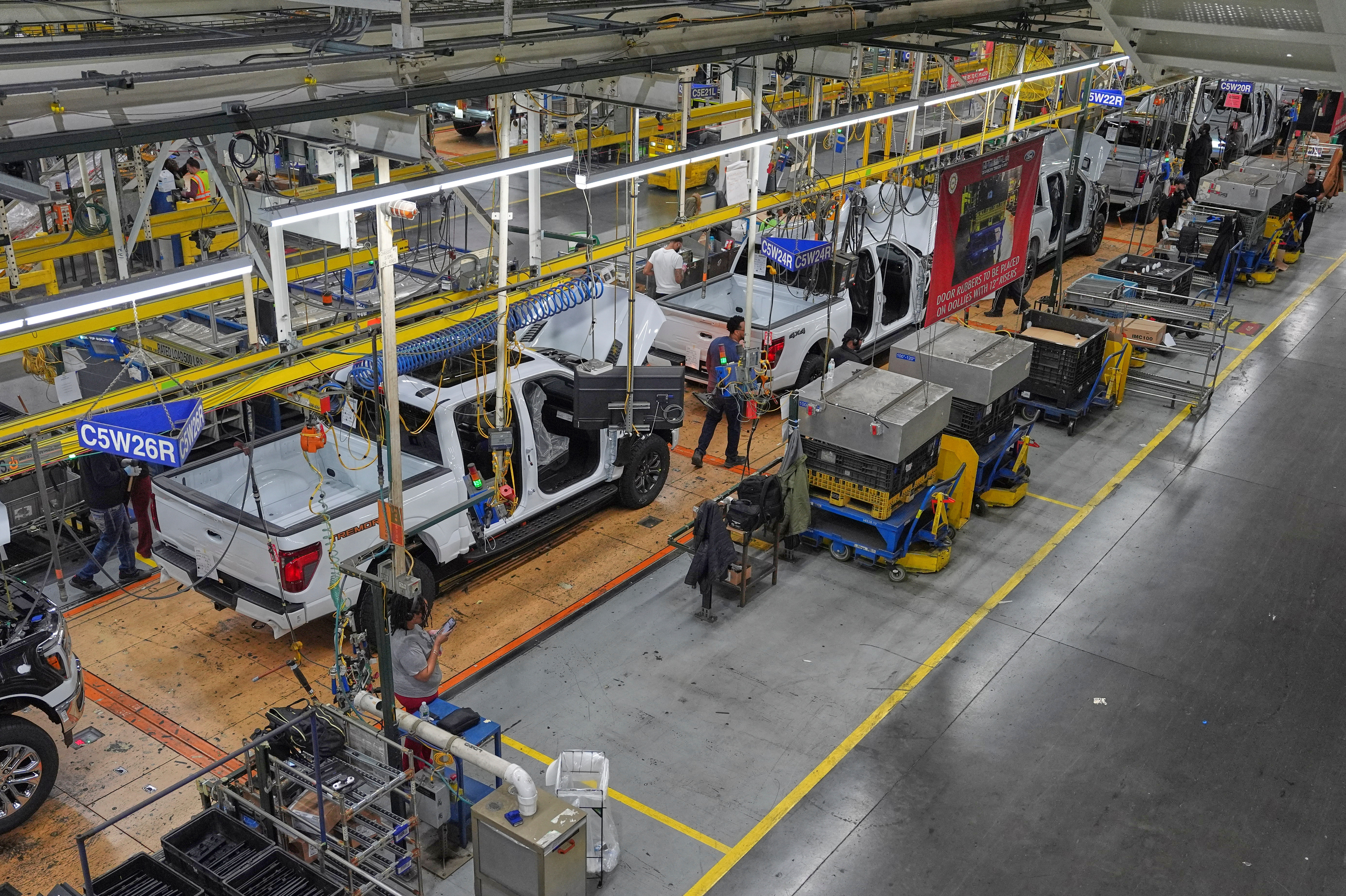 Employees work on the assembly line at the Ford River Rogue complex, Tuesday, Jan. 13, 2026, in Dearborn, Mich.