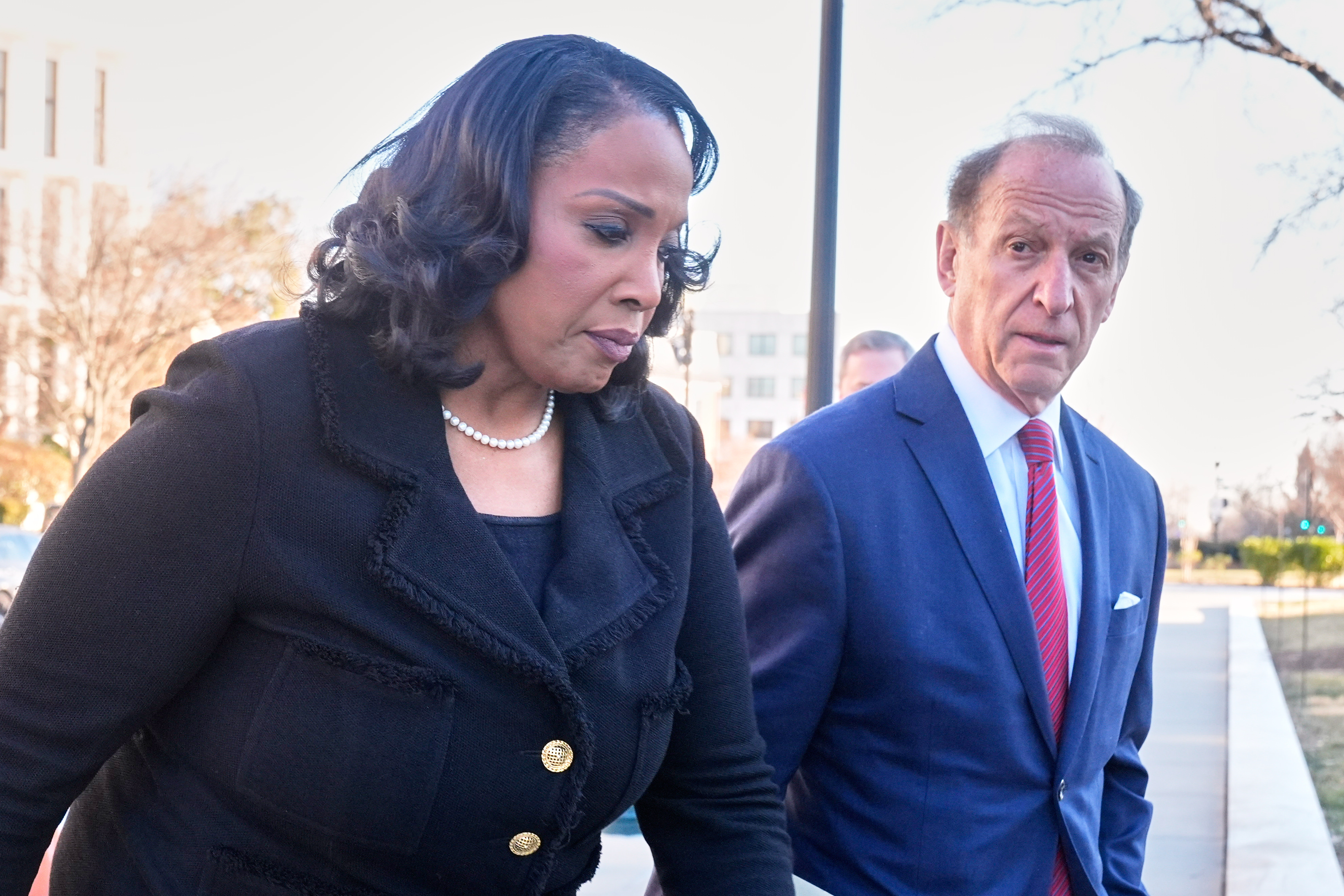Federal Reserve governor Lisa Cook and attorney Abbe Lowell arrive at the Supreme Court in Washington, Jan. 21, 2026.