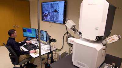 Materials Engineer Mike Meadows looks at training samples on a microelectronic microscope in the Materials Laboratory of the National Transportation Safety Board (NTSB), Tuesday, Jan. 20, 2026, in Washington.