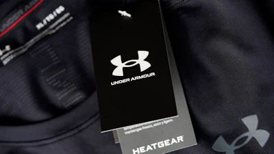 The company logo graces a sales tag on a compression shirt for sale in an Under Armour store in an outlet mall on May 3, 2021, in Lakewood, Colo.