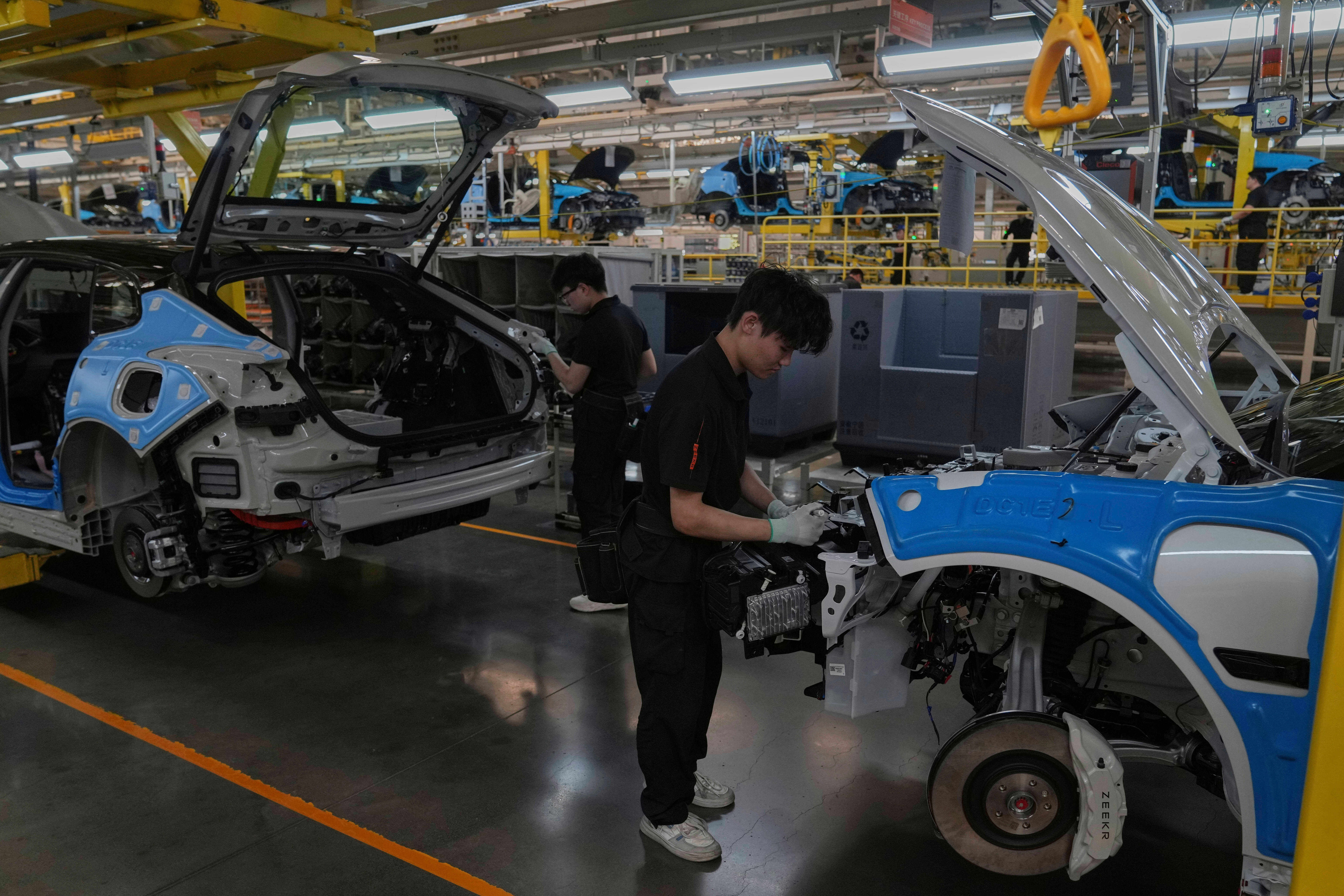 Workers assemble the Zeekr 001 EV models at the Chinese automaker Zeekr assembly plant in Ningbo, east China's Zhejiang Province, April 17, 2025.