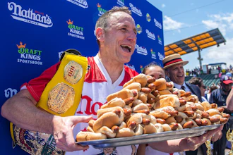 Joey Chestnut, winner of the 2021 Nathan's Famous Fourth of July International Hot Dog-Eating Contest, poses for photos in Coney Island's Maimonides Park, July 4, 2021, in the Brooklyn borough of New York.