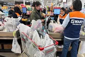 A shopper checks out in a grocery store in Schaumburg, Ill., Feb. 9, 2026.