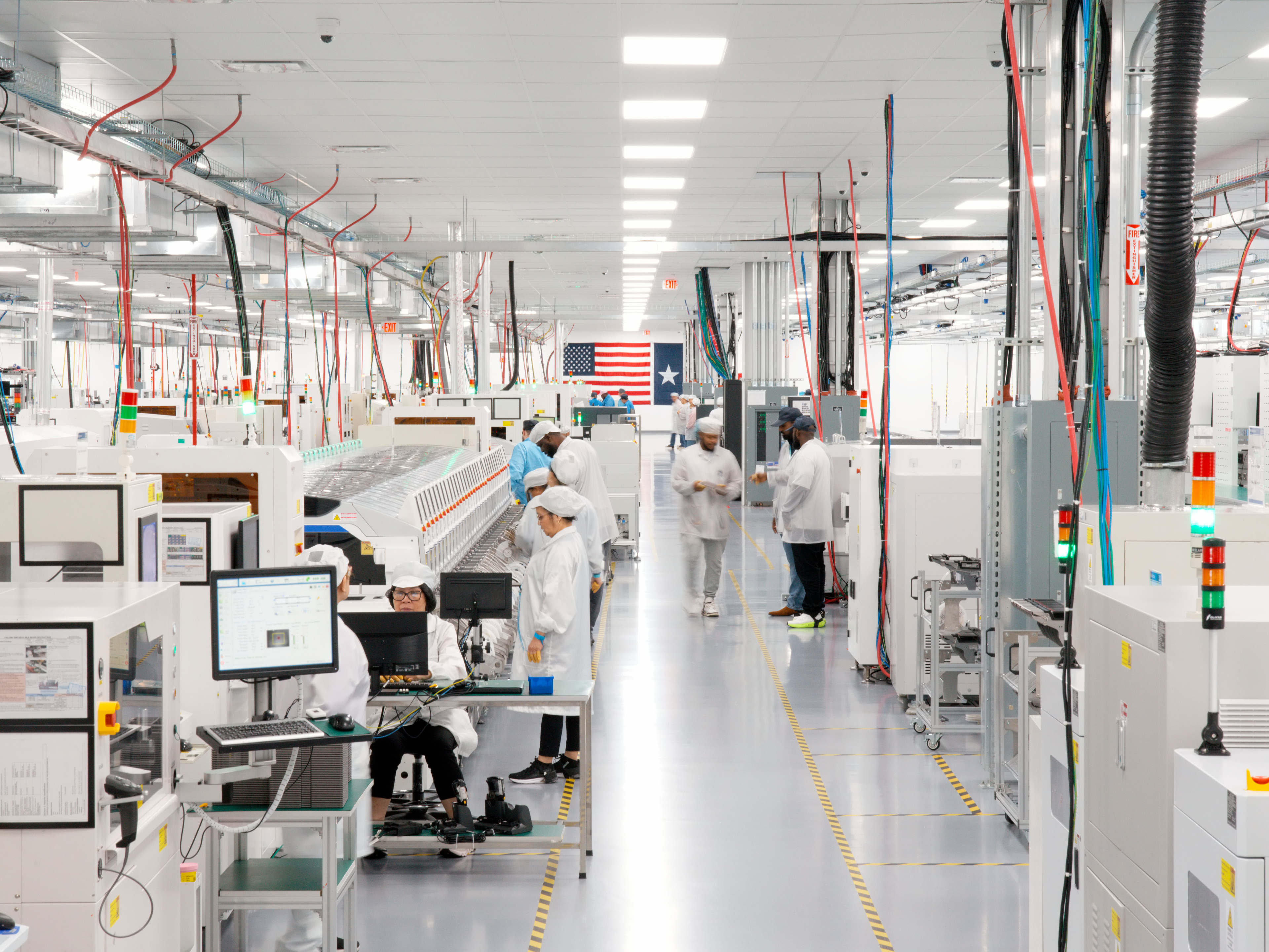 In Houston, workers assemble advanced AI servers, including logic boards produced onsite, which are then used in Apple data centers in the U.S.