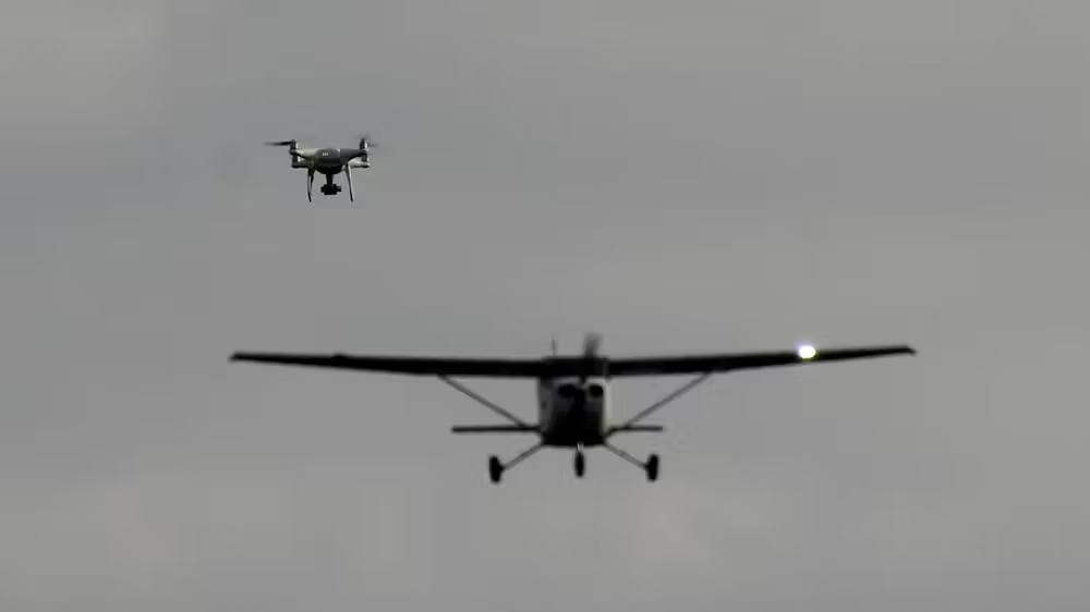 A drone flies near a small airplane in a test at Oklahoma State University.