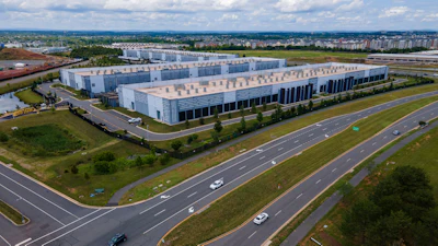 Cars drive past data centers that house computer servers and hardware required to support modern internet use, such as artificial intelligence, in Ashburn, Virginia, July 16, 2023.
