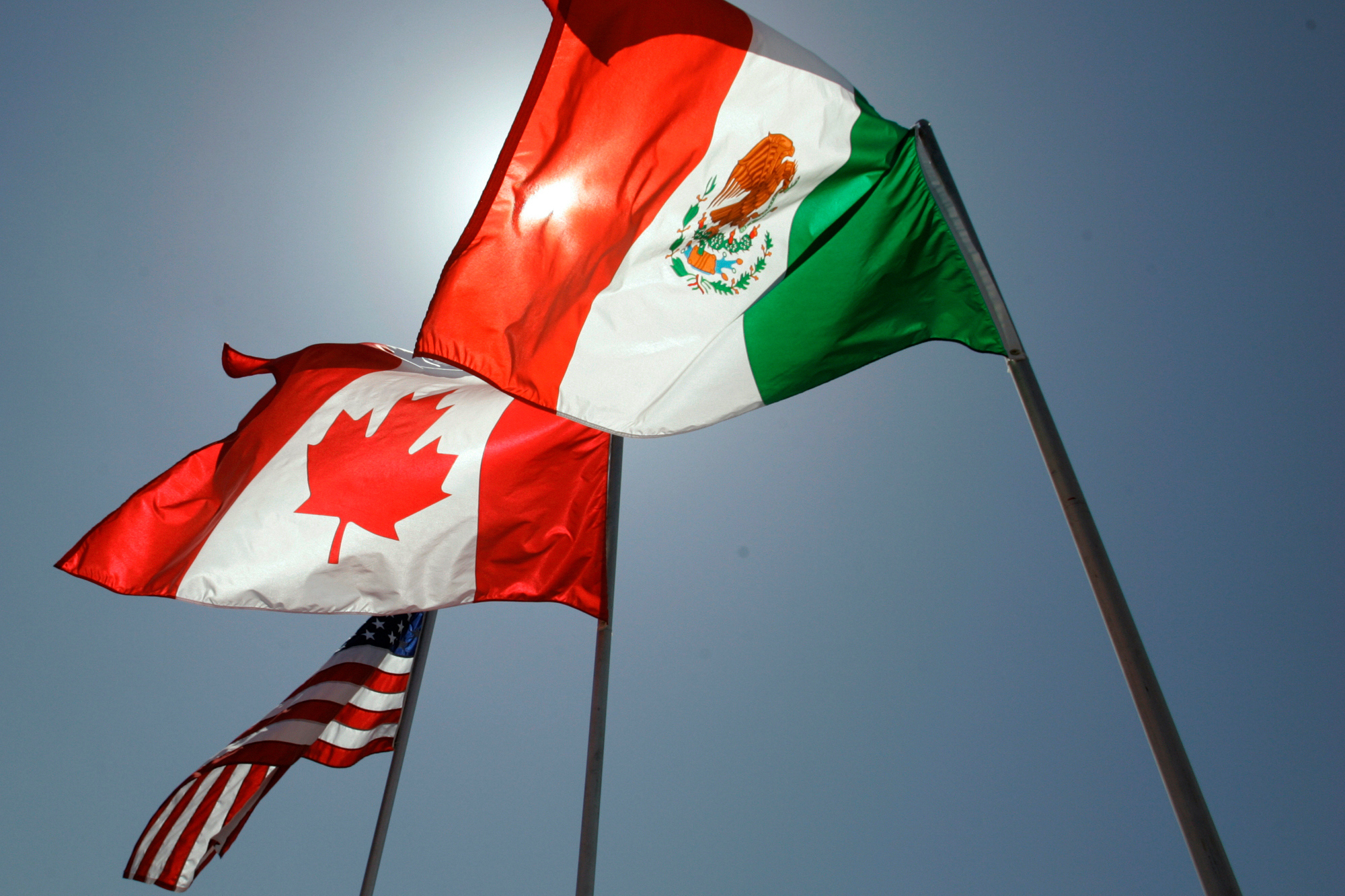 The flags of the United States, Canada, and Mexico fly in the breeze in New Orleans, where leaders of the North American Free Trade Agreement met on April 21, 2008.