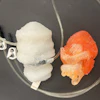 Two 3D-printed heart models. The white one replicates the left two heart chambers with a pneumatic actuator that makes it “beat.”