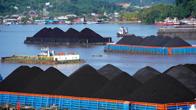 Barges fully loaded with coal are anchored on Mahakam river in Samarinda, East Kalimantan, Indonesia, on Dec. 19, 2022.