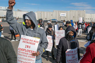 Workers from the JBS Beef Plant protest across the road from the plant on March 16, 2026 in Greeley, Colo.