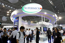 Visitors walk past a Super Micro Computer Inc. booth at the Computex Taipei exhibition in Taipei, Taiwan, June 5, 2018.
