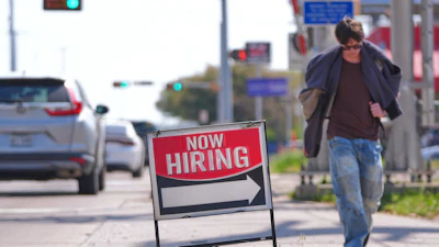 A now hiring sign on the side of the road in Garland, Texas, March 23, 2026.