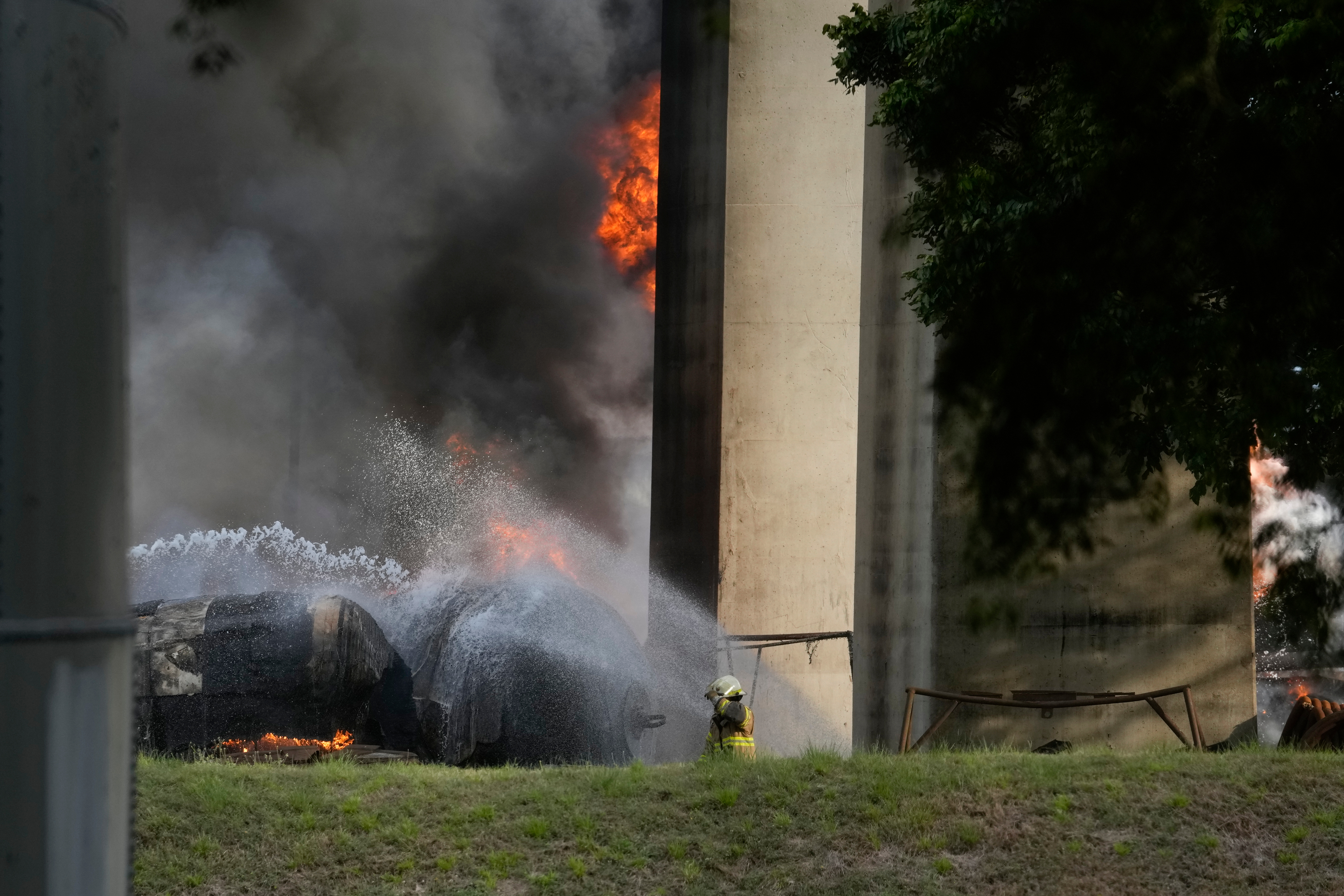 A firefighter sprays water on gas trucks that caught fire after several exploded under Las Americas Bridge, Panama City, April 6, 2026.