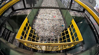 Ground up plastics that Alterra Energy receives from recycling facilities, move along a conveyor at the start of their process that transforms the material into a liquid that is then used in the manufacturing of plastic in Akron, Ohio, Sept. 8, 2022.