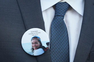 A family member wears a photo of a Boeing crash victim Danielle Moore before a hearing at federal court in Fort Worth, Texas, Sept. 3, 2025.