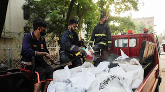 Firefighters transport the bodies of victims who lost their lives in a fire at a gas-lighter manufacturing factory in Keraniganj on the outskirts of Dhaka, Bangladesh, Saturday, April 4, 2026.