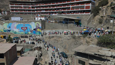 Voters line up outside a polling station during general elections in Lima, Peru, Sunday, April 12, 2026.